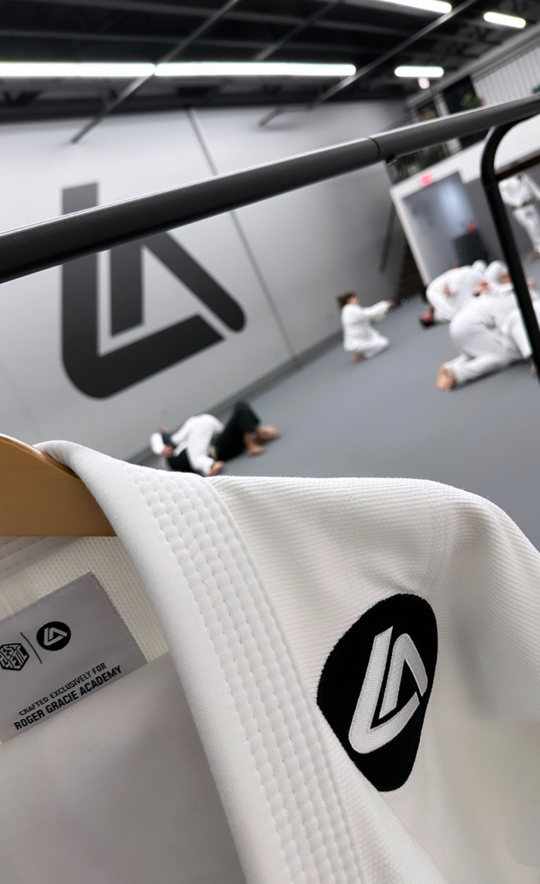 Academy gi hanging beside the mat